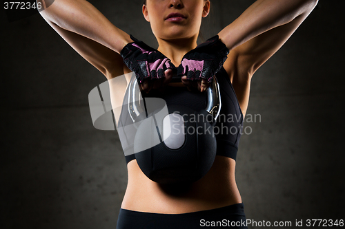 Image of close up of woman with kettlebell in gym