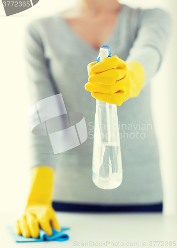 Image of close up of woman cleaning table with cloth