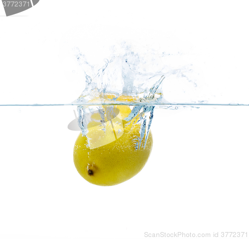 Image of lemon falling or dipping in water with splash