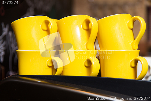 Image of close up of cups heating on coffee machine