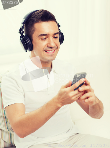 Image of happy man with smartphone and headphones
