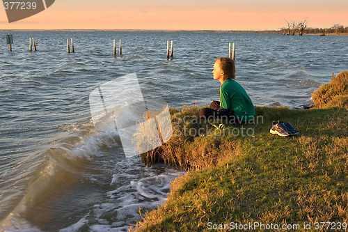 Image of boy looking over lake