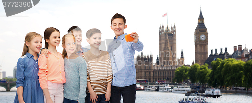 Image of happy children talking selfie by smartphone