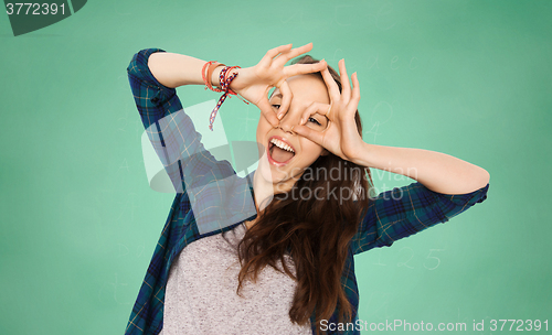 Image of happy teenage student girl having fun over green
