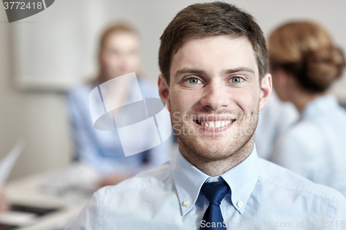 Image of smiling businessman face in office