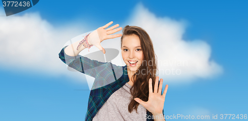 Image of happy smiling pretty teenage girl showing hands