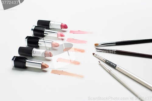 Image of close up of lipsticks range with makeup brushes