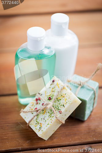 Image of close up of handmade soap bars and lotions on wood