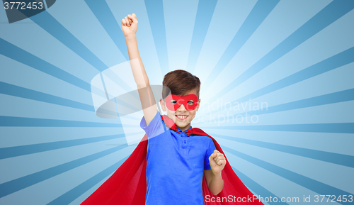 Image of boy in red super hero cape and mask showing fists