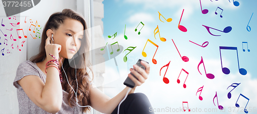 Image of teenage girl with smartphone and earphones