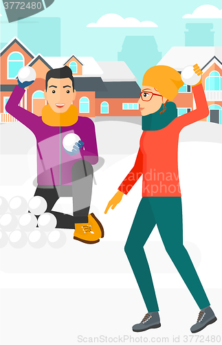 Image of Couple playing in snowballs.