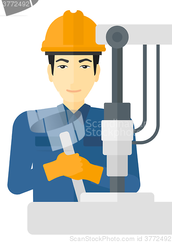 Image of Worker working with industrial equipment.