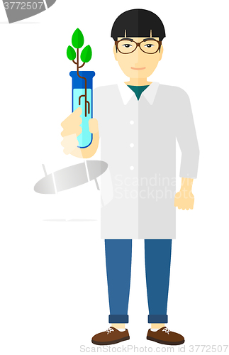 Image of Laboratory assistant with test tube.