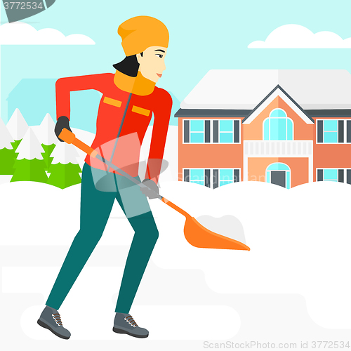 Image of Woman shoveling and removing snow.