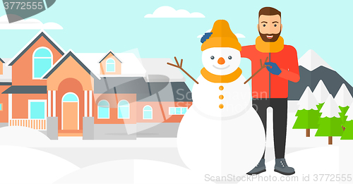 Image of Man posing near snowman.