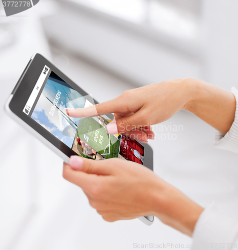 Image of close up of hands with internet app on tablet pc