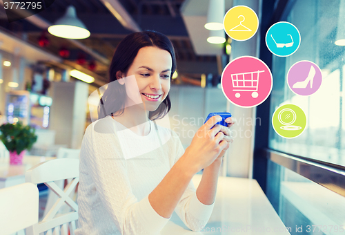 Image of smiling woman with smartphone shopping online