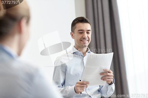 Image of smiling business people meeting in office