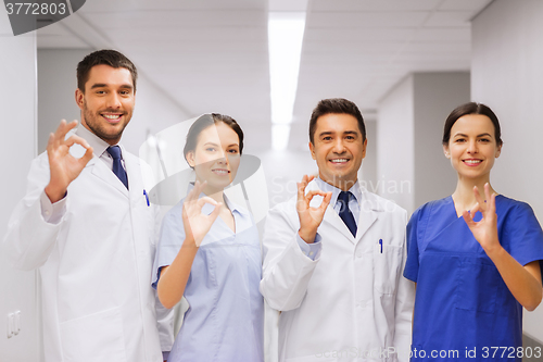 Image of group of medics at hospital showing ok hand sign