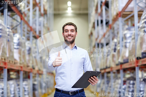 Image of happy man at warehouse showing thumbs up gesture