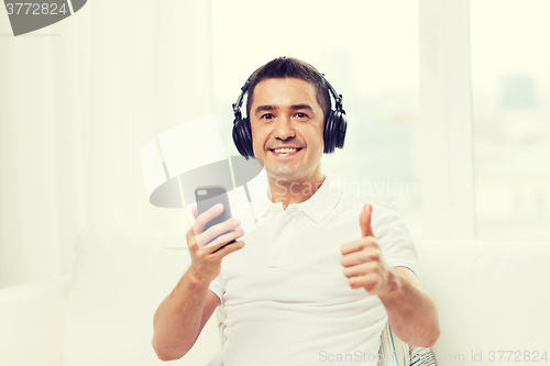 Image of happy man with smartphone and headphones