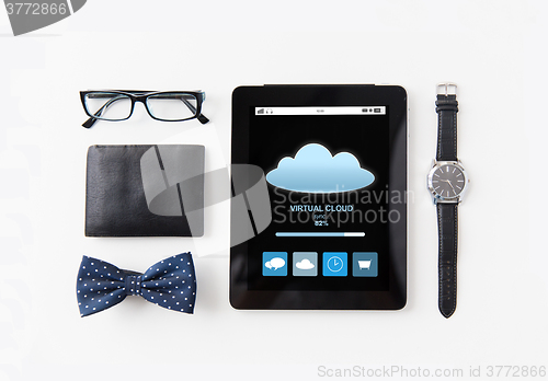 Image of tablet pc with cloud computing and personal stuff