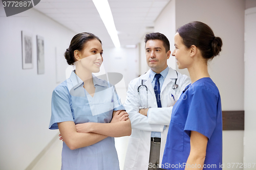 Image of group of medics or doctors talking at hospital