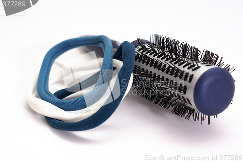 Image of hairbrush with blue elastic bands