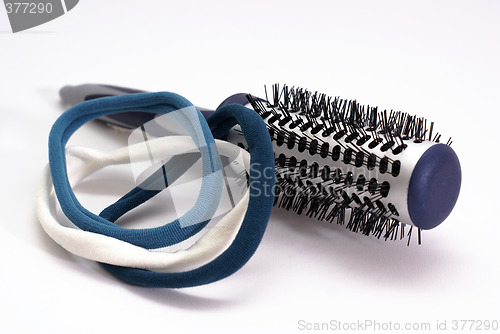 Image of hairbrush with blue elastic bands