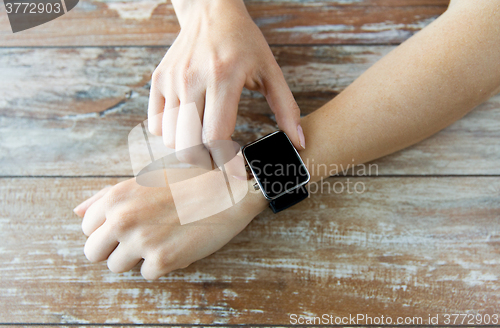 Image of close up of hands setting smart watch