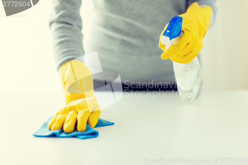 Image of close up of woman cleaning table with cloth