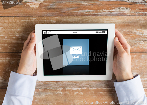 Image of close up of hands with email message on tablet pc
