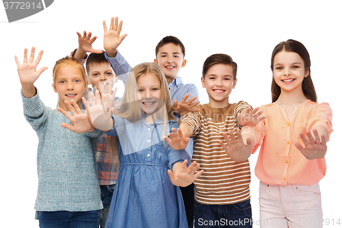 Image of happy children waving hands