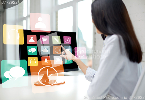 Image of close up of woman with apps on computer in office