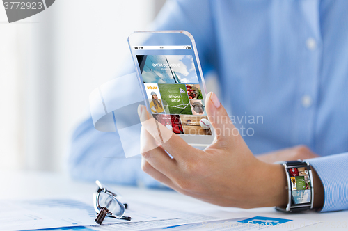 Image of close up of woman with application on smartphone