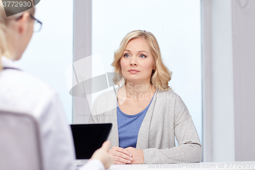 Image of doctor with tablet pc and woman at hospital