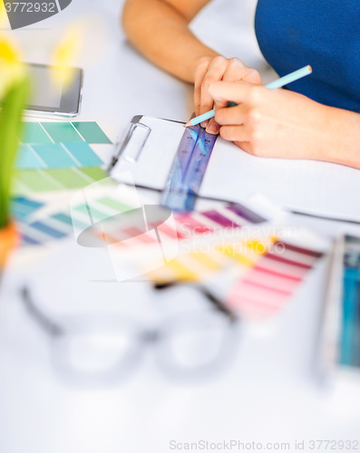 Image of woman working with color samples for selection