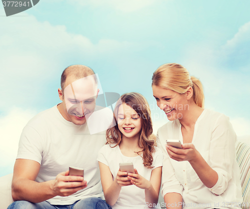 Image of happy family with smartphones