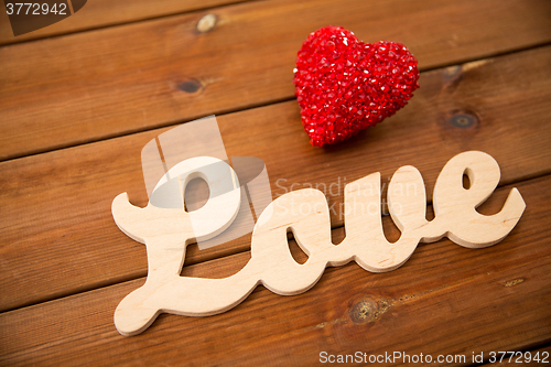 Image of close up of word love with red heart decoration