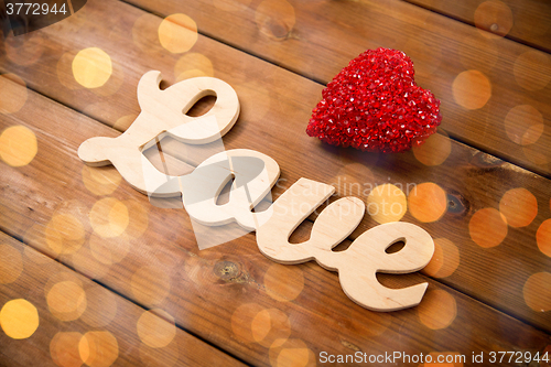 Image of close up of word love with red heart decoration