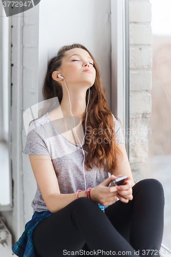 Image of teenage girl with smartphone and earphones