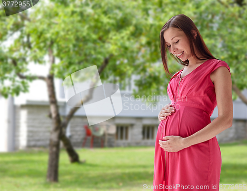 Image of happy pregnant woman with big tummy