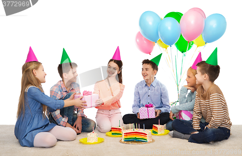 Image of happy children giving presents at birthday party