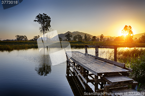 Image of Serene Sunrise over fishing Jetty