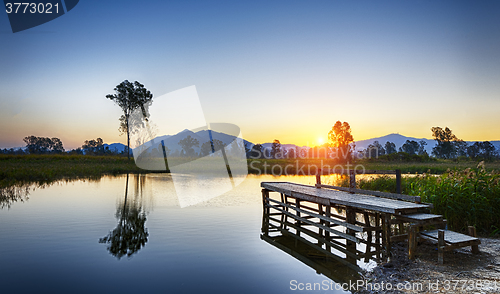 Image of Serene Sunrise over fishing Jetty