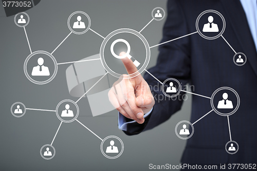 Image of business, technology and internet concept - businessman pressing search button on virtual screens