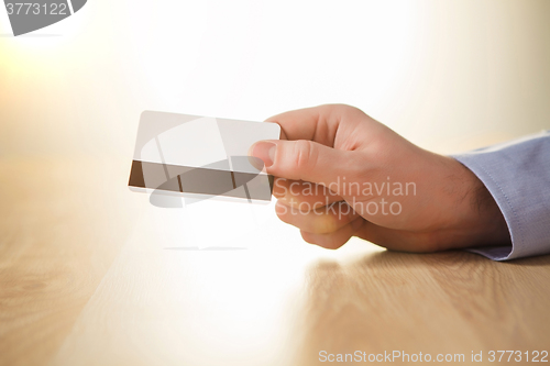 Image of The male hand showing credit card