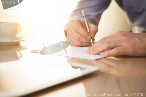 Image of The male hands with a pen