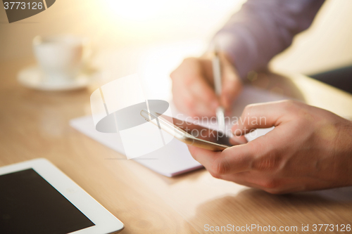 Image of The male hand holding a phone 