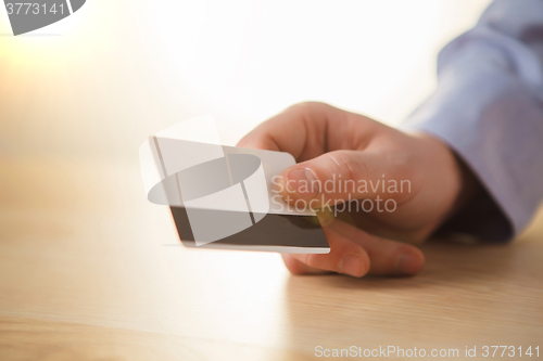 Image of The male hand showing credit card